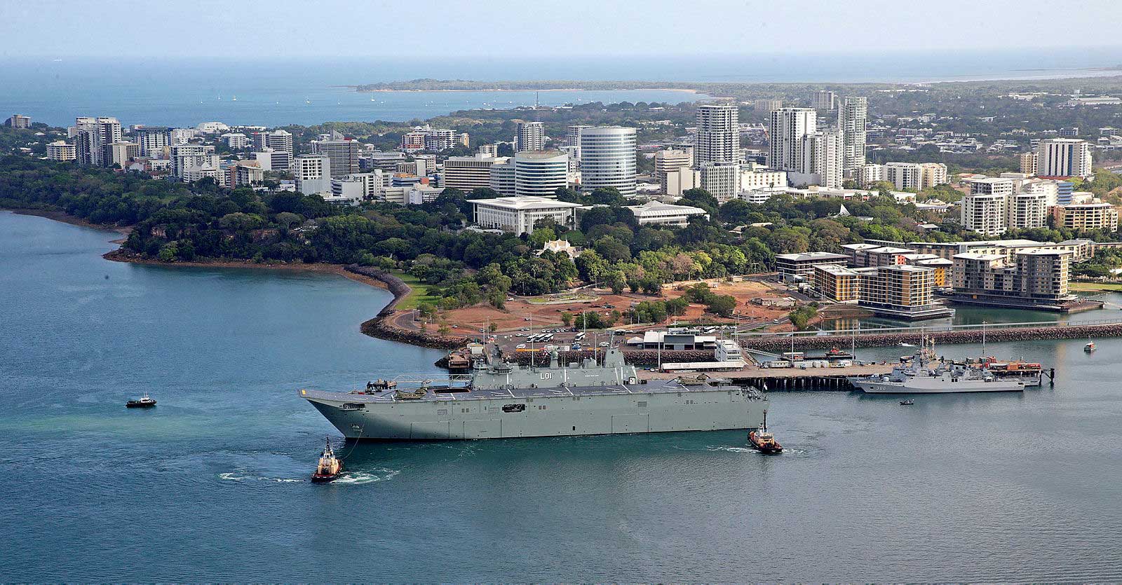 Navy ship docked at wharf.